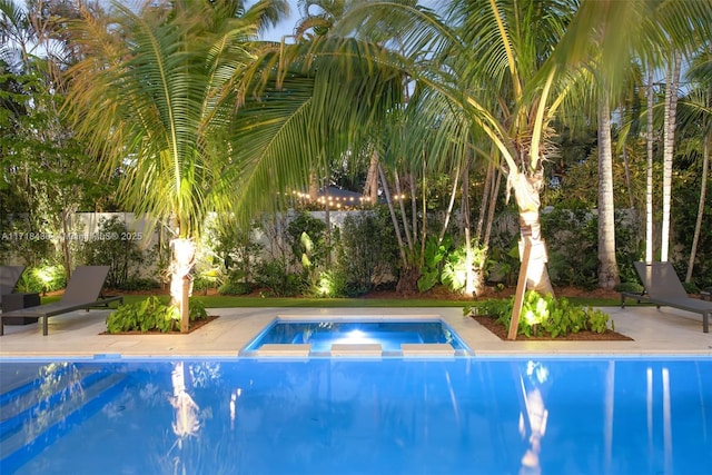 view of swimming pool with a patio area and an in ground hot tub