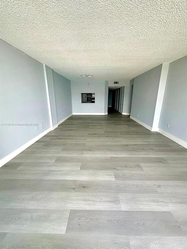 spare room with a textured ceiling