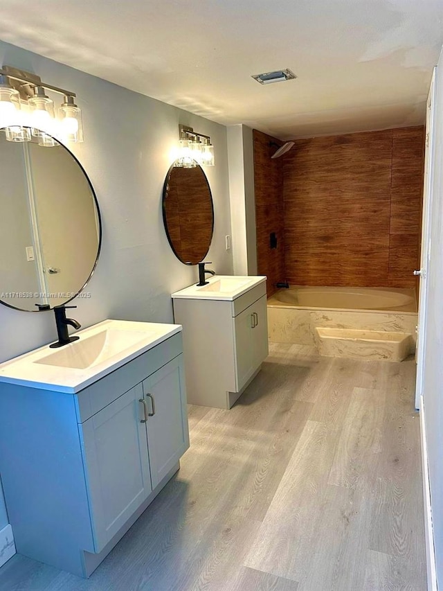 bathroom featuring shower / bathing tub combination, vanity, and hardwood / wood-style flooring