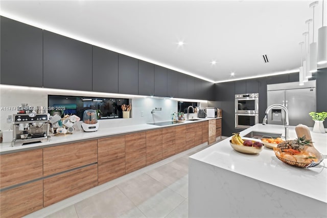 kitchen featuring light tile patterned floors, sink, and appliances with stainless steel finishes