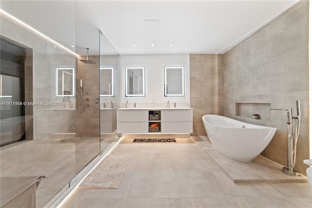 bathroom with separate shower and tub and vanity