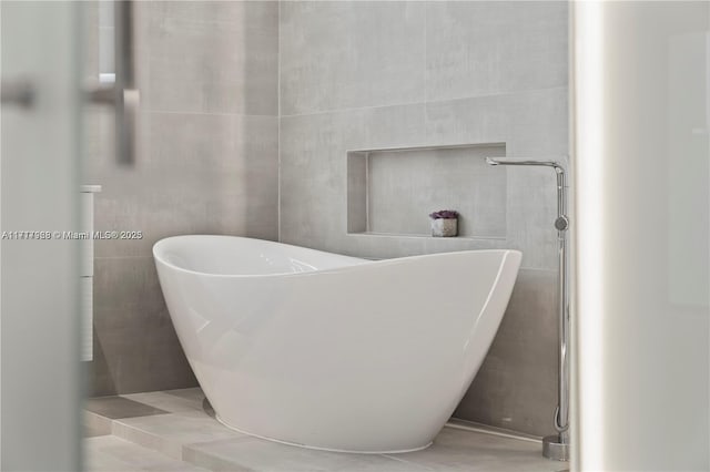 bathroom featuring a tub and tile patterned flooring