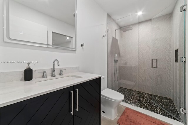 bathroom with vanity, toilet, and an enclosed shower