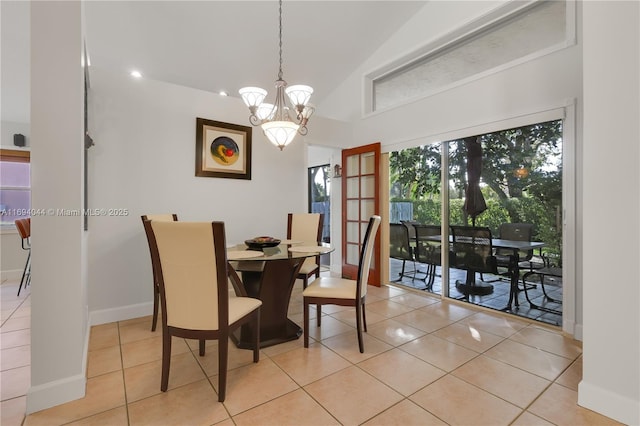 dining area with light tile patterned floors, lofted ceiling, and an inviting chandelier