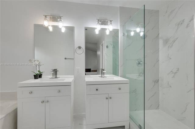 bathroom featuring tiled shower and vanity