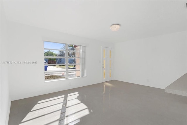 empty room with dark tile patterned floors