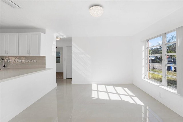 unfurnished living room featuring a healthy amount of sunlight