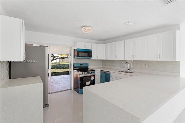 kitchen featuring kitchen peninsula, stainless steel appliances, sink, light tile patterned floors, and white cabinets