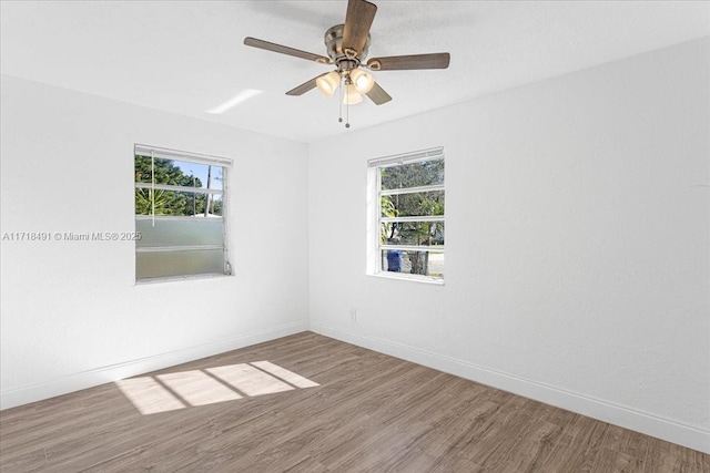 unfurnished room featuring ceiling fan and hardwood / wood-style flooring