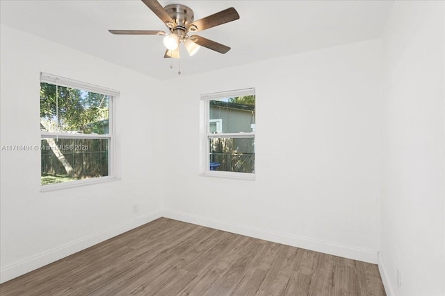 spare room with ceiling fan and wood-type flooring