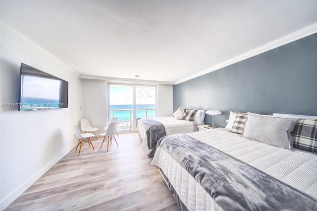 bedroom featuring crown molding and light hardwood / wood-style flooring