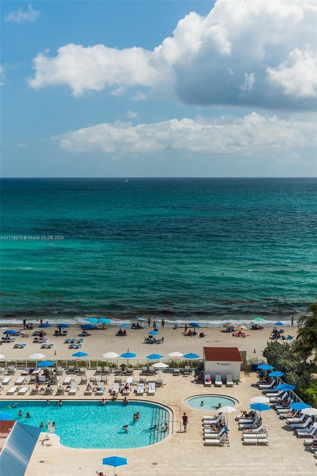 birds eye view of property with a beach view and a water view