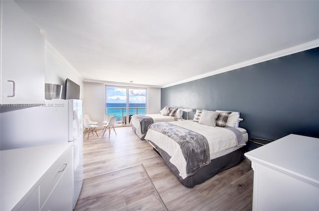 bedroom featuring crown molding and light wood-type flooring