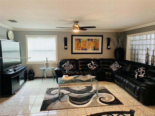 living room with ceiling fan, crown molding, and light tile patterned floors