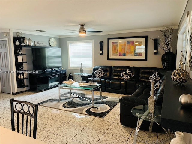 living room featuring ceiling fan and ornamental molding