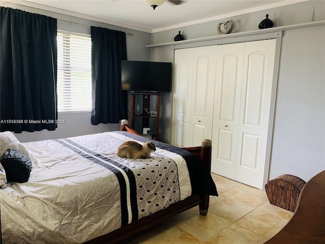 tiled bedroom with a closet and ornamental molding