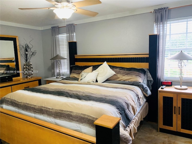 bedroom with multiple windows, ceiling fan, and ornamental molding