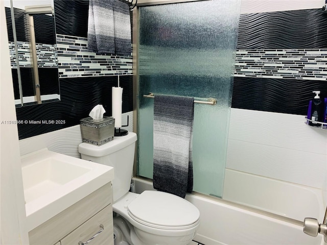 full bathroom featuring shower / bath combination with glass door, vanity, and toilet