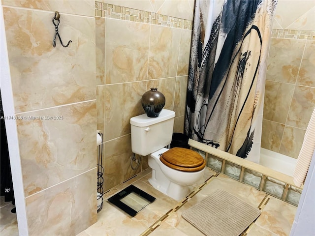 bathroom featuring toilet, tile walls, and walk in shower