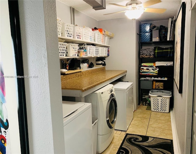 clothes washing area featuring ceiling fan, light tile patterned floors, and independent washer and dryer