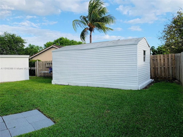 view of outdoor structure featuring a lawn