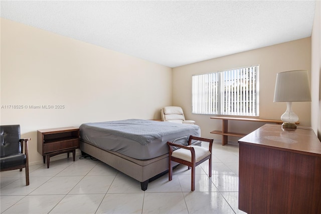 tiled bedroom with a textured ceiling