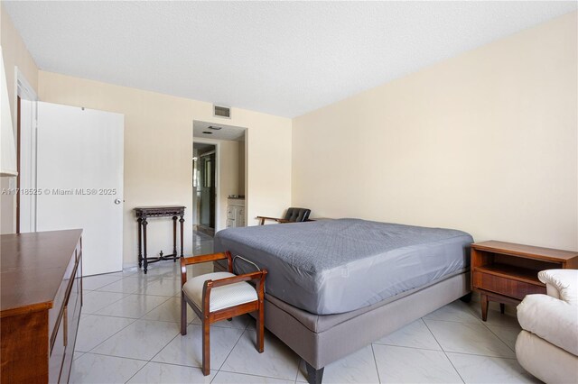 bedroom featuring light tile patterned floors