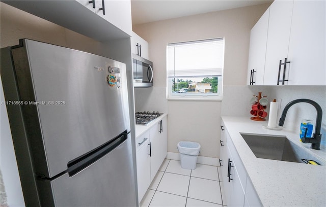 kitchen with white cabinets, sink, and stainless steel appliances