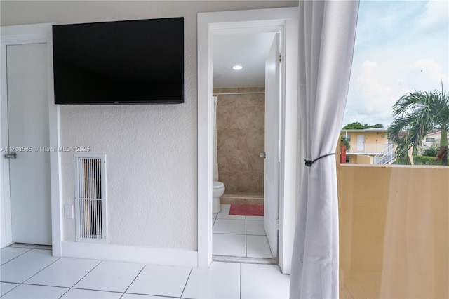 bathroom featuring tile patterned flooring and toilet