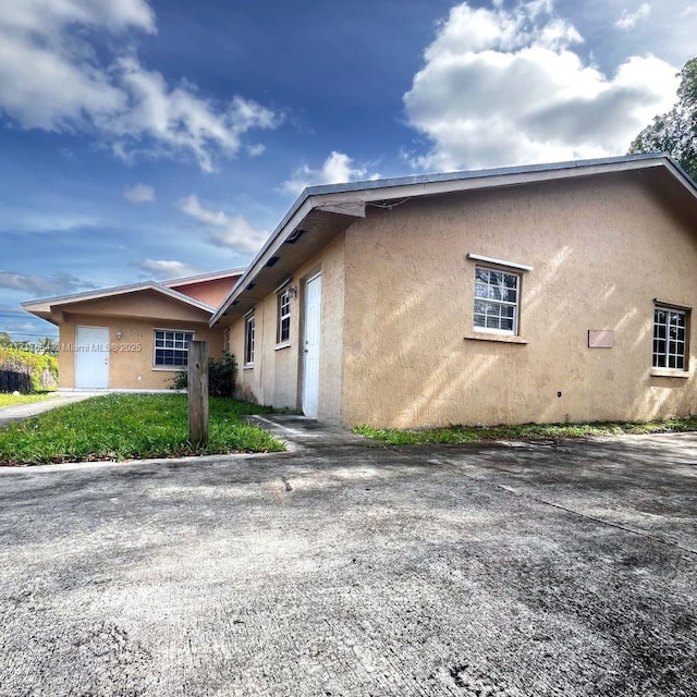 view of side of home with a yard