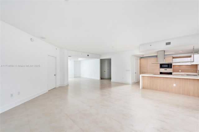 unfurnished living room with sink