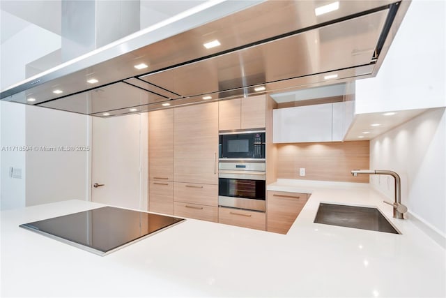 kitchen featuring black appliances, backsplash, sink, and light brown cabinetry