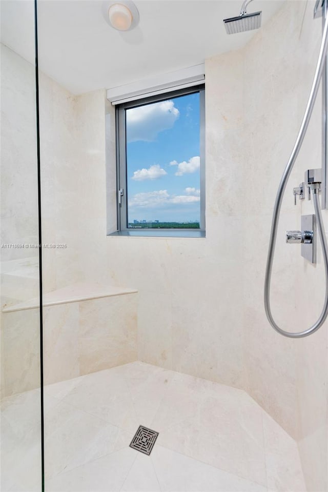 bathroom with tiled shower