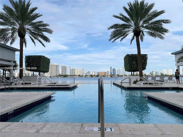 view of dock featuring a community pool and a water view