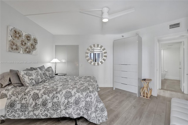 bedroom featuring ensuite bath, ceiling fan, and light hardwood / wood-style floors