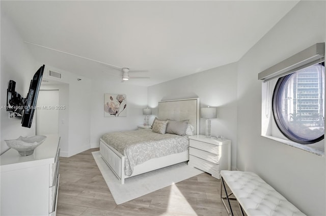 bedroom with light wood-type flooring and ceiling fan