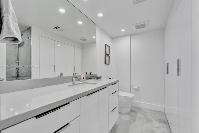 bathroom featuring vanity, toilet, and walk in shower