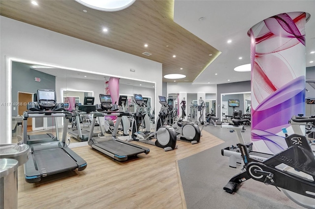 workout area featuring hardwood / wood-style floors and wood ceiling