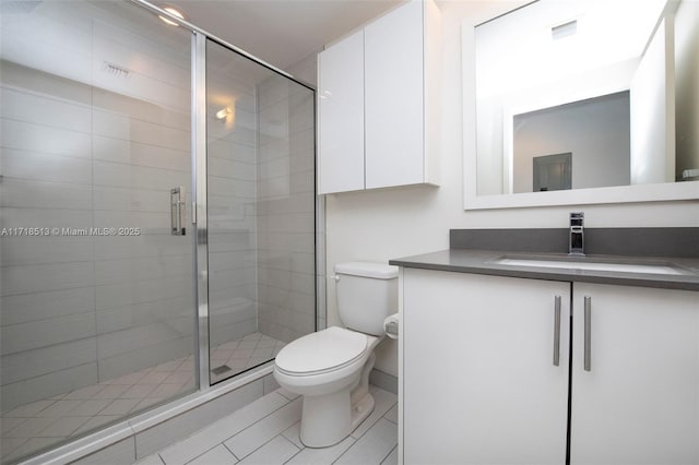 bathroom with an enclosed shower, vanity, and toilet