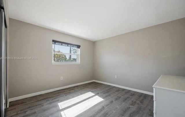 spare room featuring dark hardwood / wood-style flooring