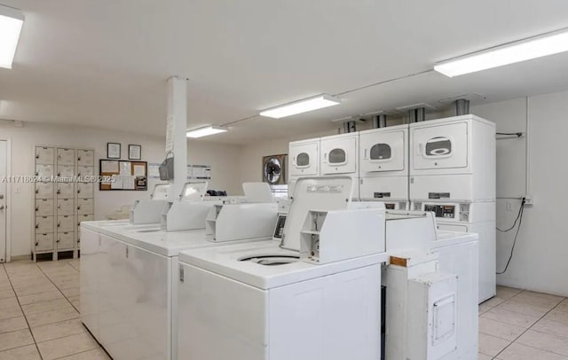 laundry area featuring stacked washer / drying machine, light tile patterned flooring, and separate washer and dryer