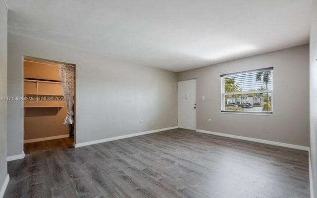 spare room with dark hardwood / wood-style floors