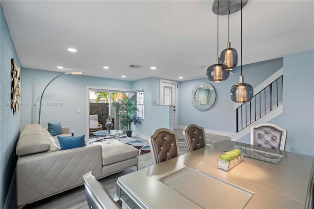 dining space featuring hardwood / wood-style floors and a textured ceiling