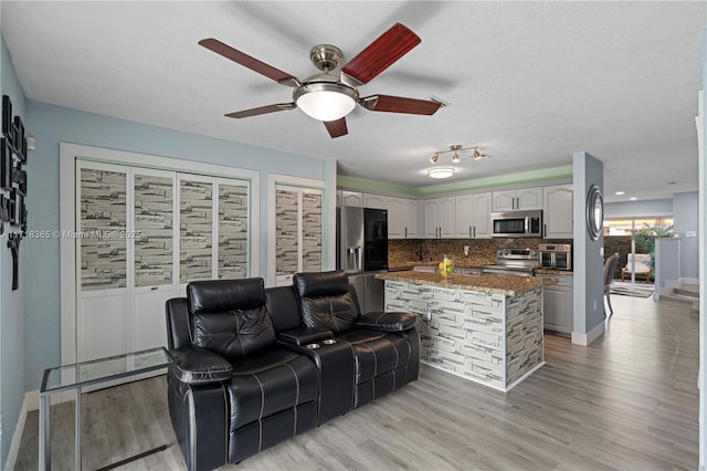 living room featuring a textured ceiling and light hardwood / wood-style floors