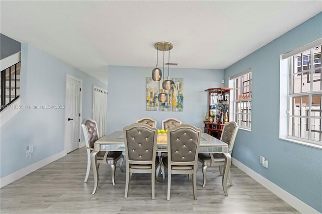 dining space featuring light hardwood / wood-style flooring