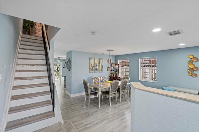 dining room with ceiling fan and hardwood / wood-style floors