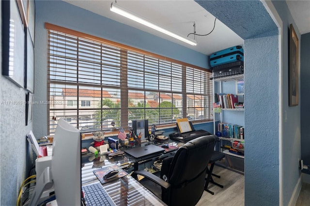 home office with light hardwood / wood-style floors