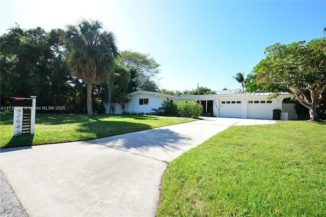 ranch-style house featuring a garage and a front yard