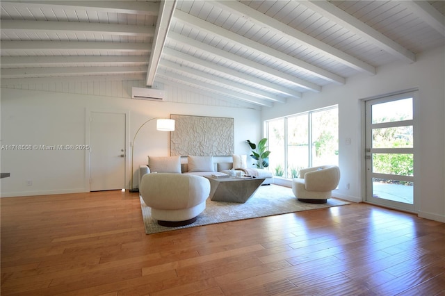 living room featuring hardwood / wood-style flooring, vaulted ceiling with beams, and a wall mounted AC