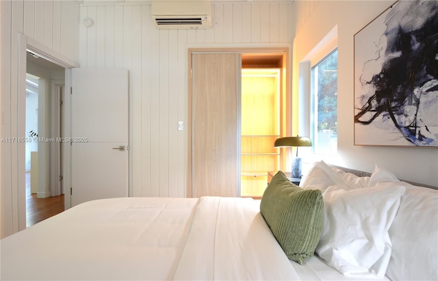 bedroom with a wall mounted air conditioner and wooden walls